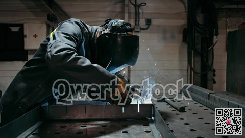 Workers in industrial uniform and welded iron mask in steel factories, first industrial safety concept. Slow motion in low light.