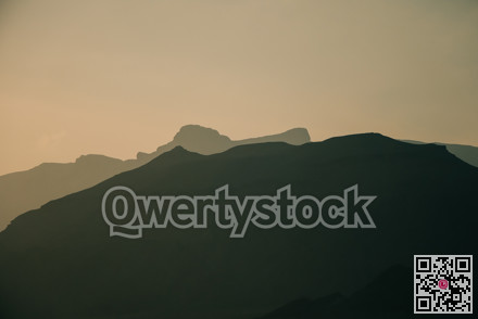 Peaceful coastal and mountain landscape featuring subdued colors suitable for backgrounds and travel articles