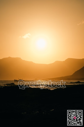 Sun sets beautifully. Evening glow shapes coastlines with bright reflections and tranquil atmosphere