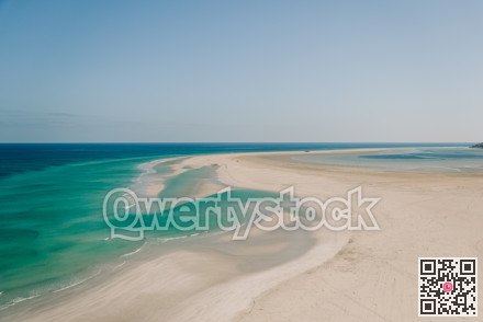 Minimalist travel visuals featuring expansive turquoise waters and sweeping shoreline curves