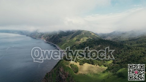 Vast oceanfront cliff edge offering panoramic views of rugged coastlines and rolling pastures