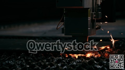 Industrial laser process. Molten droplets illuminate textured surface during intense metal cutting