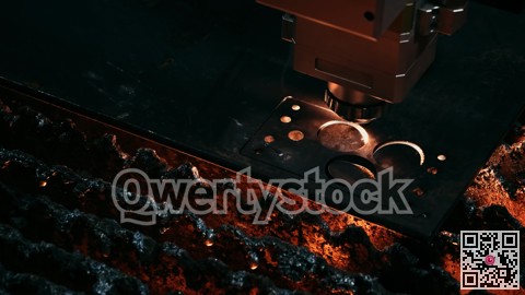 Heavyduty fabrication environment showcasing plasma cutter creating circular shapes in steel surface