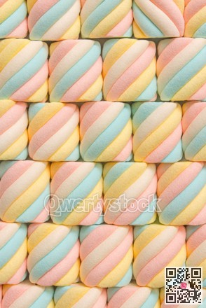 Bright pastel confections arranged precisely. Decorative marshmallow designs in organized diagonal layout
