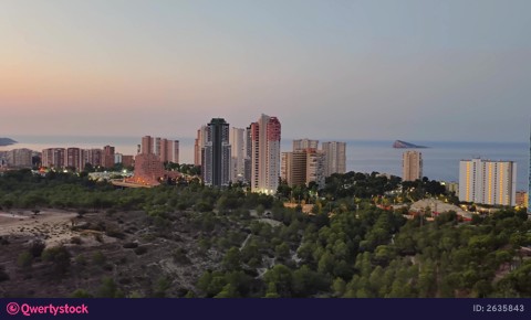Experience a Stunning Aerial View of a Coastal City at Dusk, a truly captivating spectacle video 2635843
