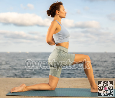 Portrait of sporty woman practicing various yoga poses on seashore