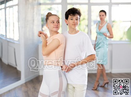 Girl and a boy are having fun learning to dance tango at choreographic school