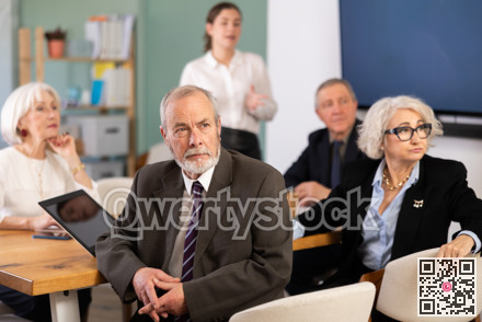 Businessman watching presentation while gathering in meeting room