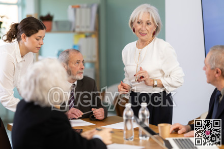 Female leader, trainer talking to group of people, brainstorming, discussing ideas in auditory