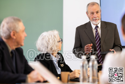 Elderly man presenting with remote control