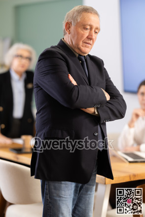Upset senior man conference participant or partner is reprimanded