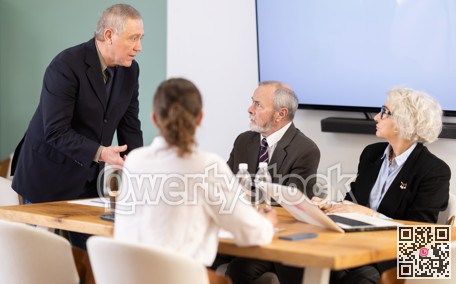 Male leader, trainer talking to group of people, brainstorming, discussing ideas in auditory