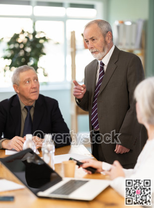 Male leader, trainer talking to group of people, brainstorming, discussing ideas in auditory