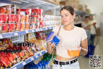 Female shopper choosing traditional Chinese noodles in supermarket
