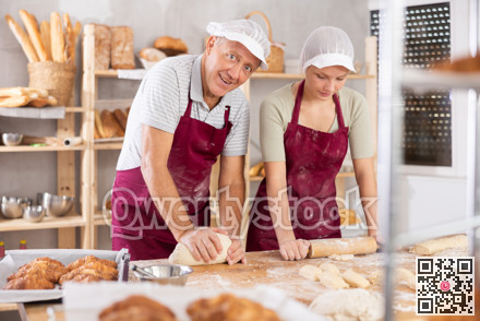 Pensioner man and girl make dough, employee kneads lump of dough, assistant works with rolling pin