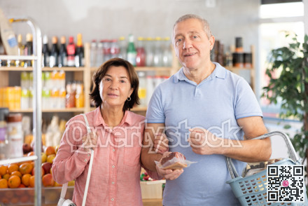 Senior family couple is looking for fresh produce together in grocery supermarket
