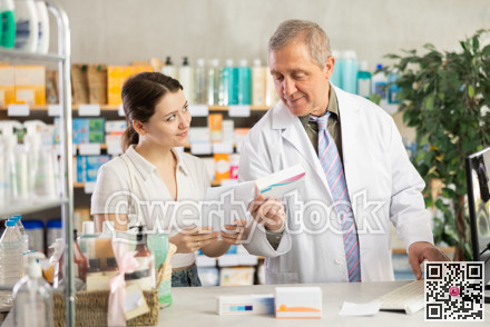 Senior man pharmacist use computer, girl intern with prescription