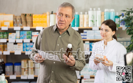 Man choosing pills with help from pharmacist