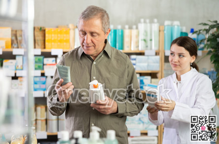 Senior man buys cream at drug store, girl pharmacist in background