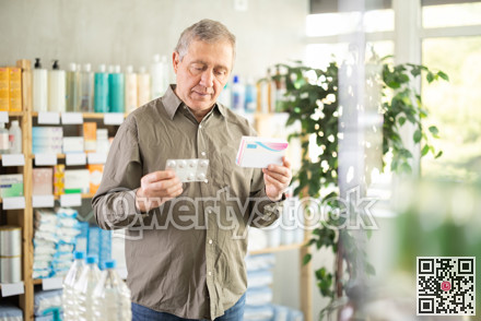 Senior man buys pills at pharmacy