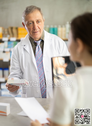 Senior man pharmacist consulting female client