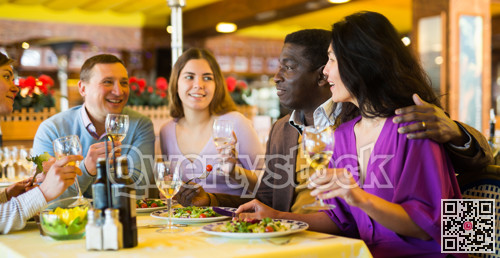 Happy adult people having fun in restaurant during dinner