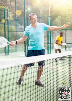Man playing padel tennis on court