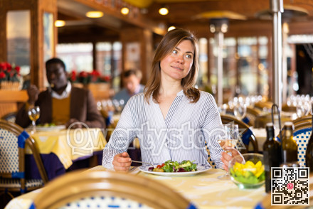 Portrait of woman enjoying delicious lunch in restaurant