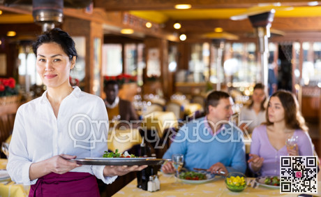 Portrait of asian waitress standing in restaurant