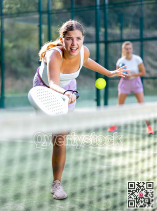 Active womans with enthusiasm playing padel on tennis court