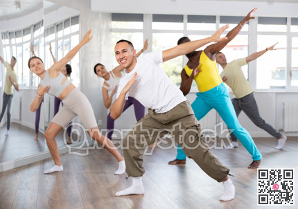 European guy with team of like-minded multinational people learn to elements of hip hop dance