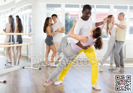 Woman dances incendiary tango with African man partner during choreography lesson