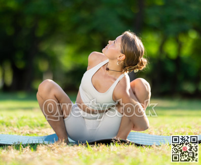 Girl in park on green grass of lawn performs Malasana