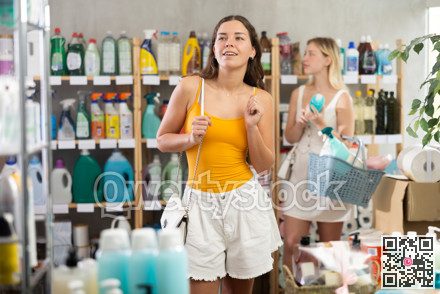 Young girl in summer clothes looking around other choosing something