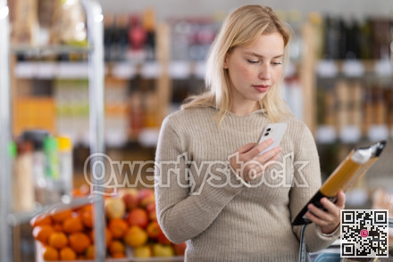Young woman scanning qr code for spaghetti
