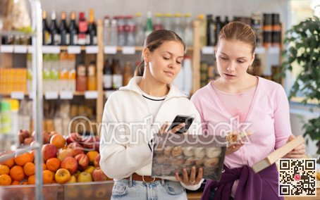 Young women scanning qr code for sweets