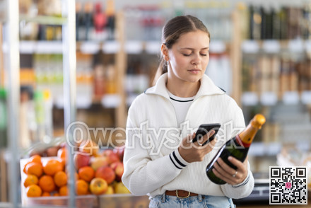 Girl shopper scanning QR code on bottle champagne label in grocery department of supermarket