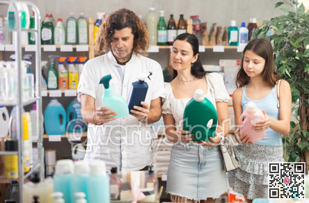 Family choosing laundry detergent in store during summer