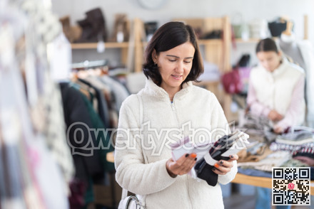 Adult woman chooses socks in clothing store