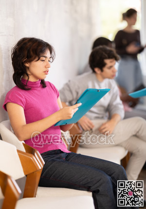 Young girl applicant sitting in a queue at a modern office
