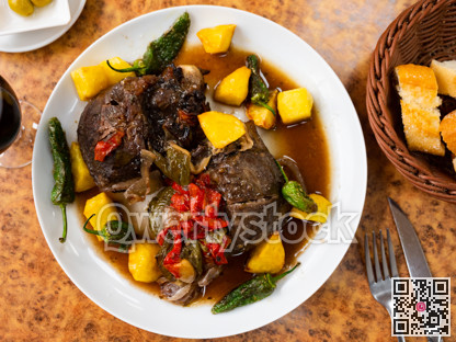 Baked pork cheeks served with potatoes