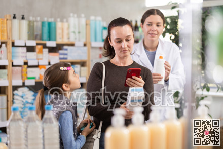 Woman with daughter scanning barcode on skincare lotion to check ingredient