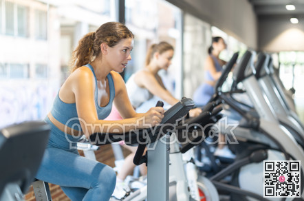 Woman exercising on an exercise bike in the gym