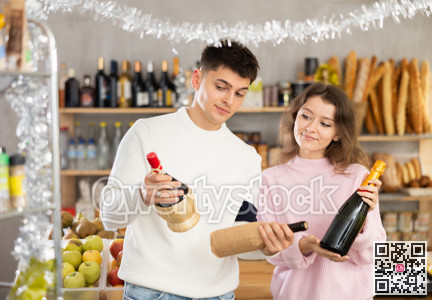 Couple man and woman choosing wine