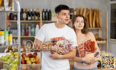 Couple man and woman choosing groceries in store