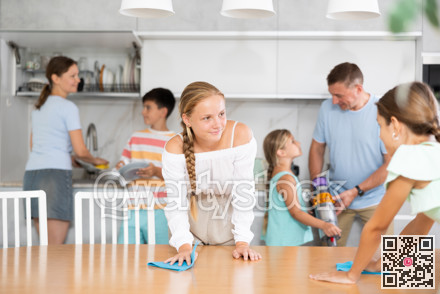 Children in large family help their parents to clean room