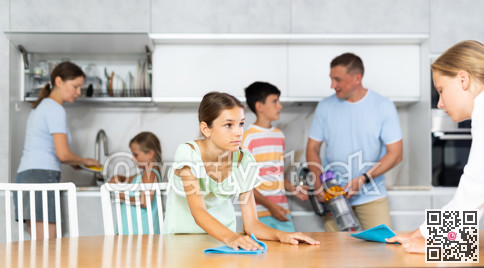 Children in large family help their parents to clean room