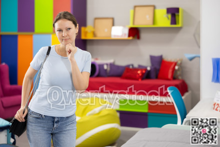 Interested woman choosing functional furniture for home in shop