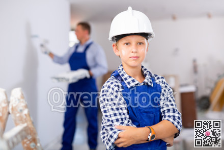 Preteen boy posing on indoor construction site
