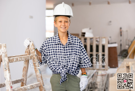 Preteen boy posing on indoor construction site